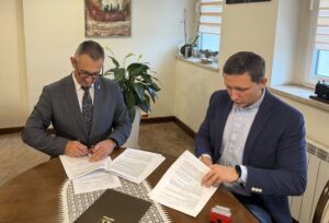 Na zdjęciu widoczny wójt oraz pan Marek Smolarek podczas podpisywania umowy.